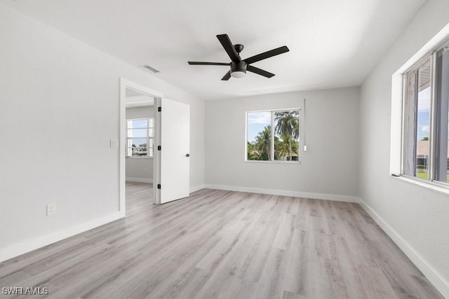 spare room with light hardwood / wood-style floors and ceiling fan