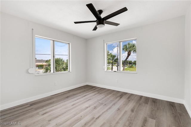 unfurnished room featuring ceiling fan, baseboards, a healthy amount of sunlight, and wood finished floors