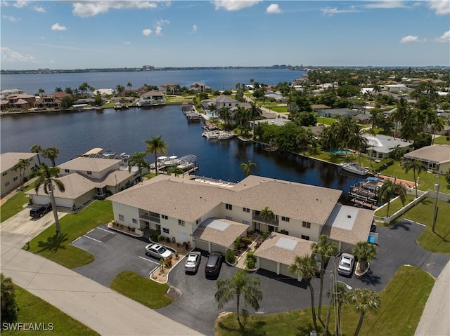 drone / aerial view with a residential view and a water view