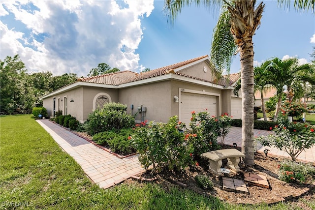 view of property exterior with a garage and a lawn