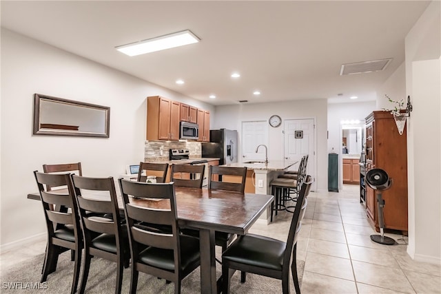 tiled dining area featuring sink