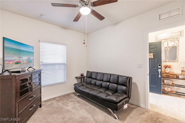 sitting room with ceiling fan and light colored carpet