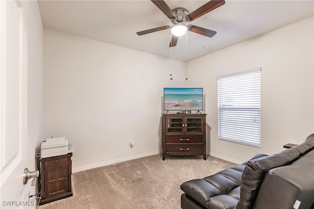 sitting room featuring ceiling fan and light colored carpet