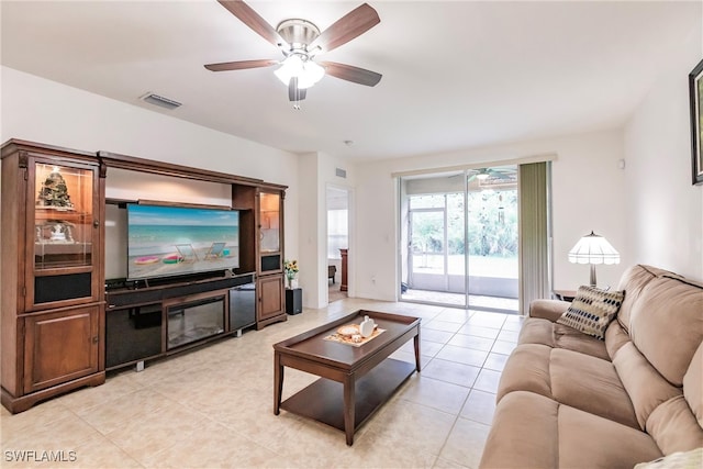 tiled living room with ceiling fan