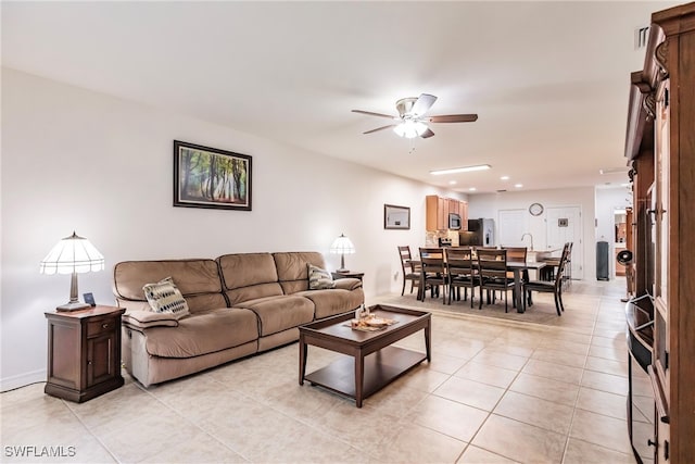 living room with ceiling fan and light tile patterned floors