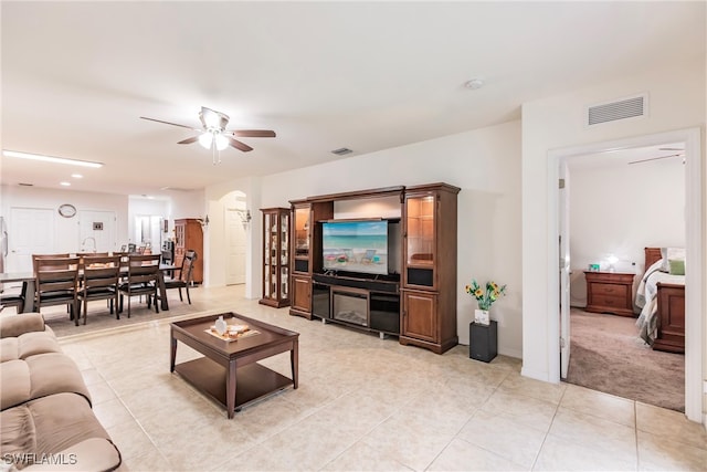 tiled living room featuring ceiling fan