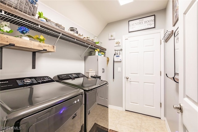 washroom featuring washing machine and clothes dryer and light tile patterned floors