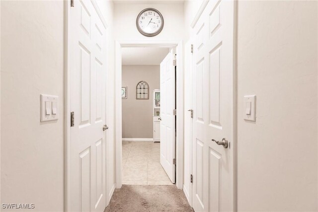 hallway with light tile patterned floors