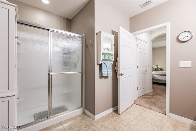 bathroom featuring a shower with shower door and tile patterned floors