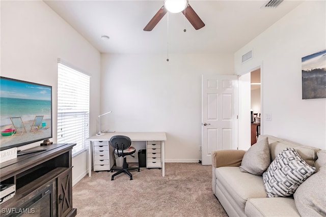 home office with light carpet and ceiling fan