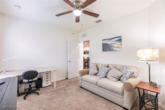 carpeted office space with ceiling fan