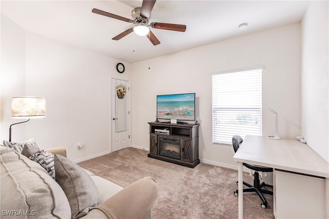 carpeted home office featuring ceiling fan