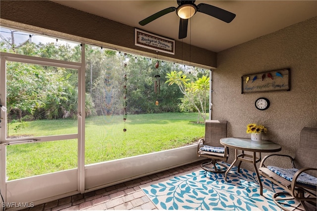 sunroom featuring ceiling fan