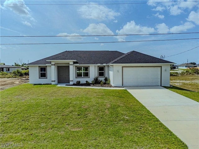 view of front of property featuring a garage and a front yard