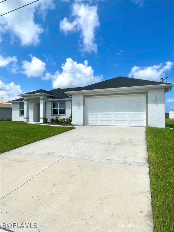 single story home with a garage and a front lawn