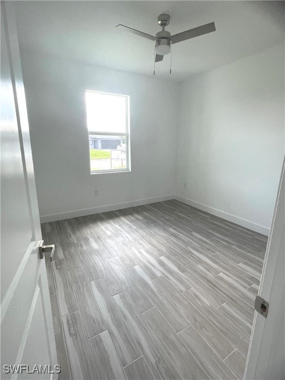 spare room featuring ceiling fan and light hardwood / wood-style floors