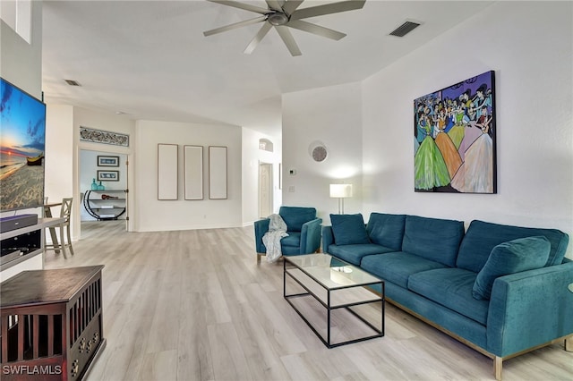 living room featuring ceiling fan and light hardwood / wood-style floors