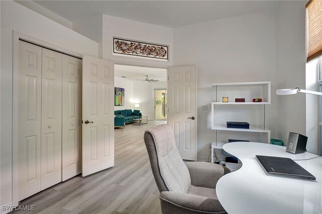 home office featuring ceiling fan and light hardwood / wood-style flooring