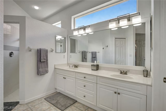 bathroom featuring walk in shower, vanity, tile patterned floors, and lofted ceiling