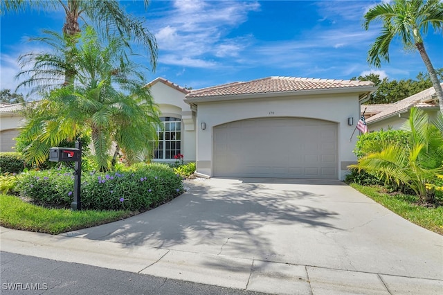 mediterranean / spanish-style home with a garage