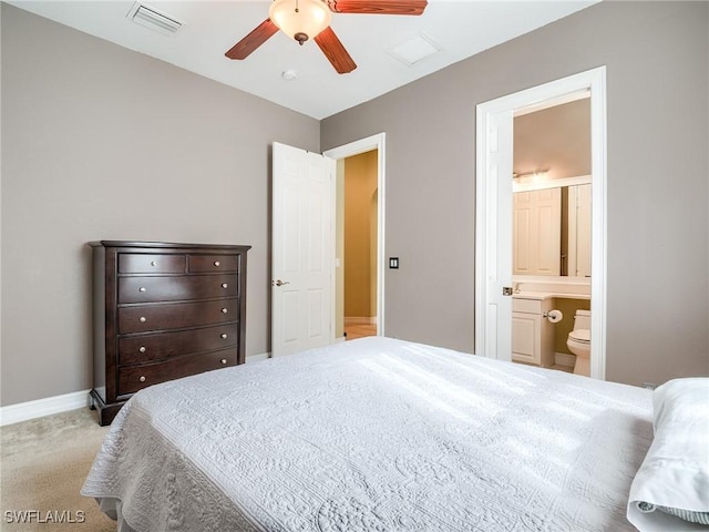 bedroom with light carpet, ensuite bath, and ceiling fan