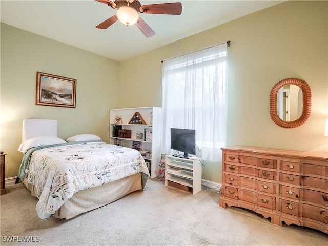 bedroom featuring light carpet and ceiling fan