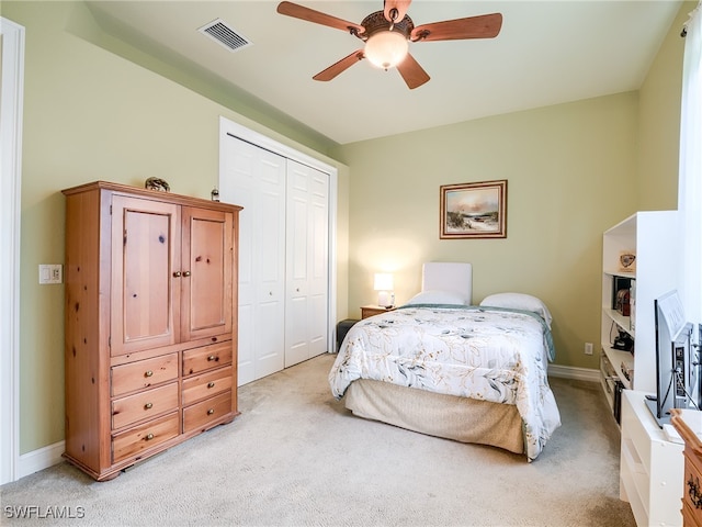 bedroom with light carpet, a closet, and ceiling fan