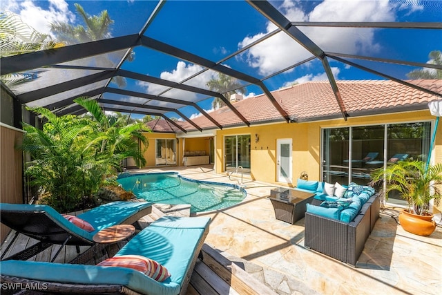 view of pool featuring a lanai, outdoor lounge area, and a patio area