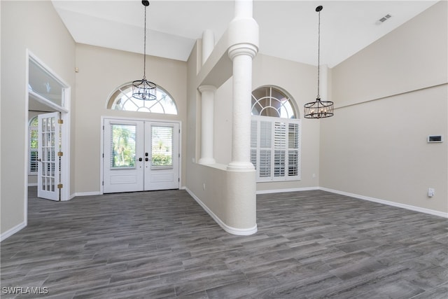 entrance foyer with french doors, ornate columns, and dark wood-type flooring