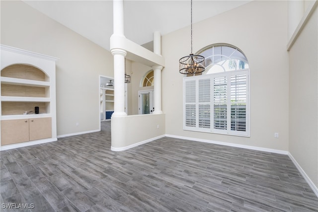 interior space featuring dark wood-type flooring and high vaulted ceiling