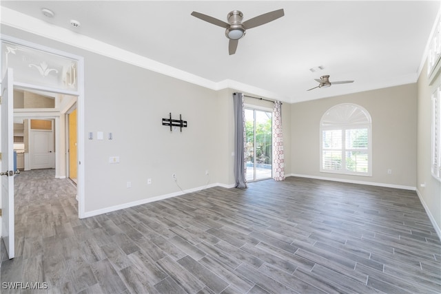 spare room featuring ceiling fan, hardwood / wood-style floors, and crown molding