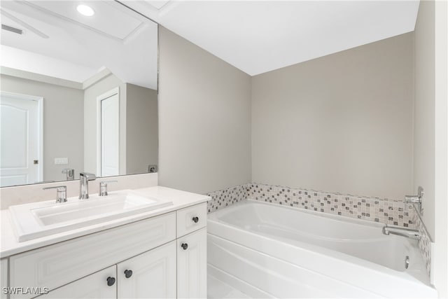 bathroom with vanity and a tub