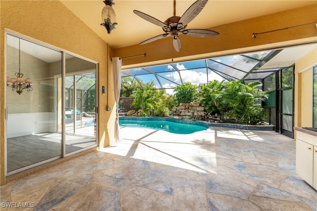 view of pool featuring a patio, ceiling fan, and glass enclosure