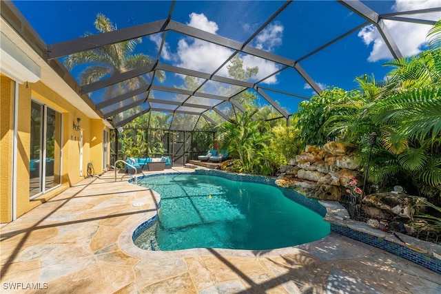 view of swimming pool featuring glass enclosure and a patio area