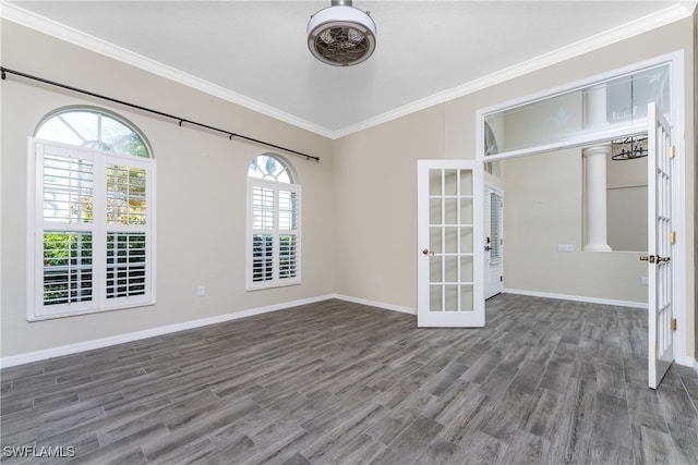 unfurnished room with ornamental molding, dark wood-type flooring, french doors, and a wealth of natural light