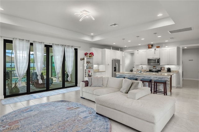 living room featuring a raised ceiling