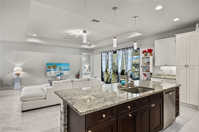 kitchen featuring white cabinetry, a raised ceiling, dishwasher, and sink