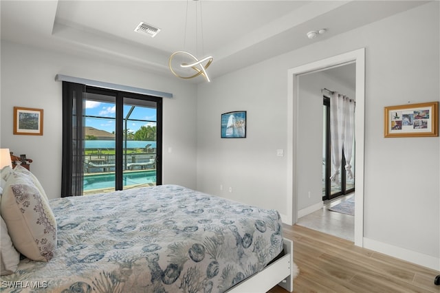 bedroom featuring light hardwood / wood-style flooring and access to exterior