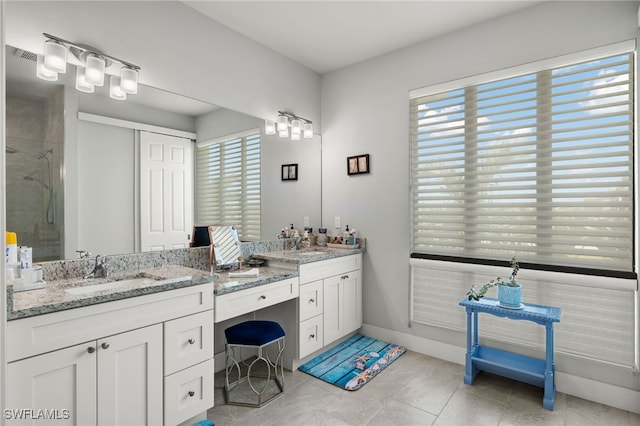 bathroom featuring a wealth of natural light, vanity, tile patterned floors, and an enclosed shower