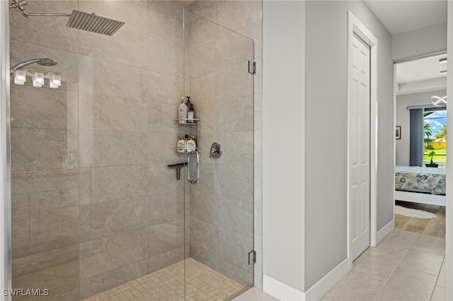 bathroom featuring a shower with door and tile patterned floors