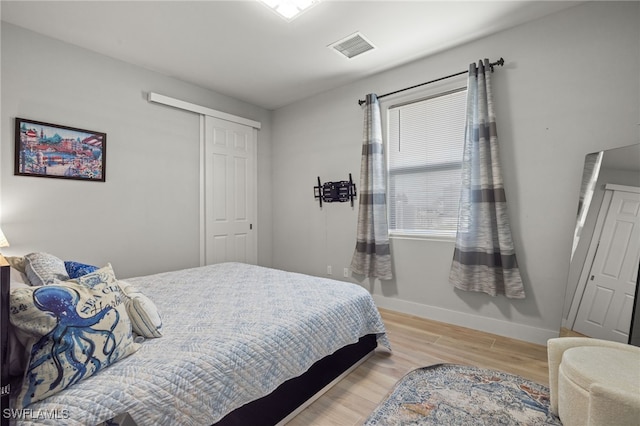 bedroom featuring light wood-type flooring and a closet