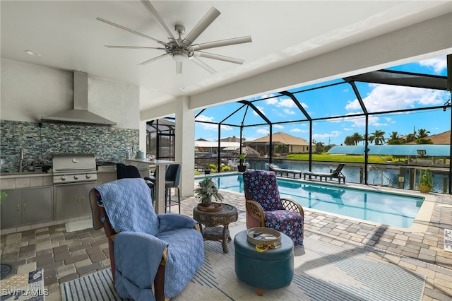 view of pool featuring a lanai, a patio, a water view, area for grilling, and ceiling fan