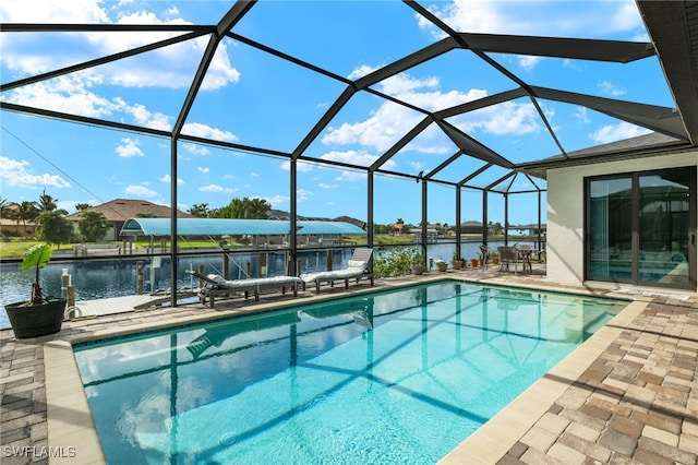 view of swimming pool with a water view, a lanai, and a patio area