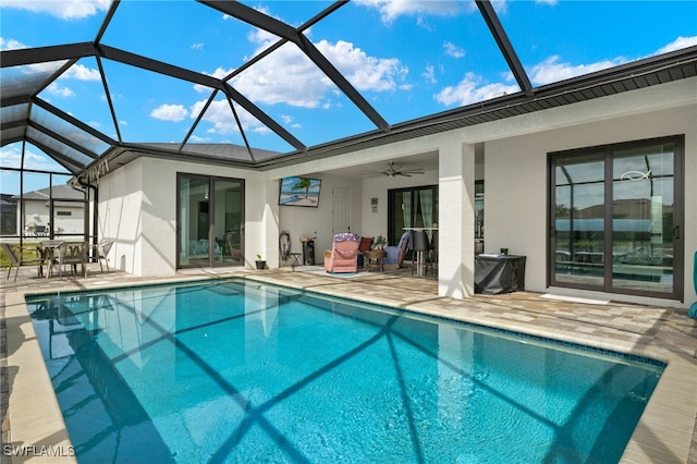 view of pool with a lanai, ceiling fan, and a patio area