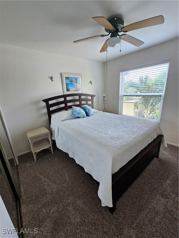 bedroom featuring dark colored carpet and ceiling fan