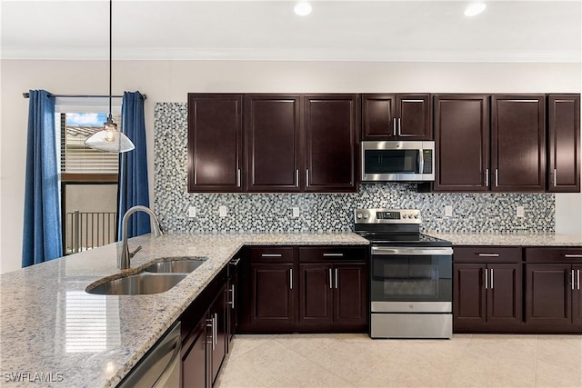 kitchen with light stone countertops, sink, stainless steel appliances, decorative light fixtures, and ornamental molding