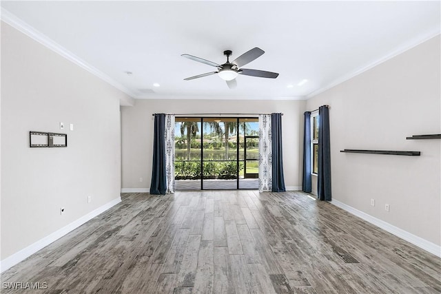 spare room with wood-type flooring, ceiling fan, and ornamental molding