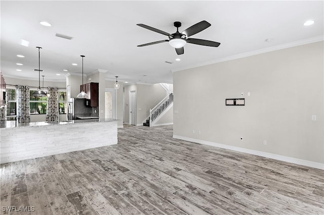 unfurnished living room with ceiling fan, light hardwood / wood-style floors, and ornamental molding