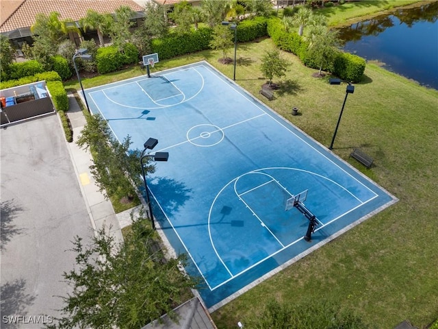 view of sport court featuring a lawn and a water view