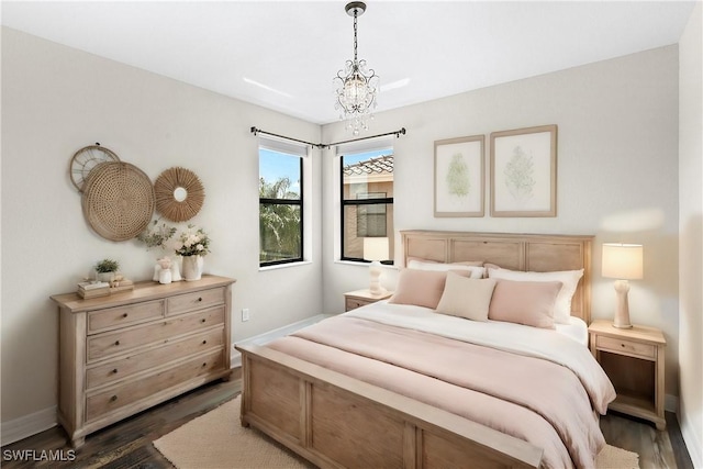 bedroom featuring a chandelier and dark wood-type flooring